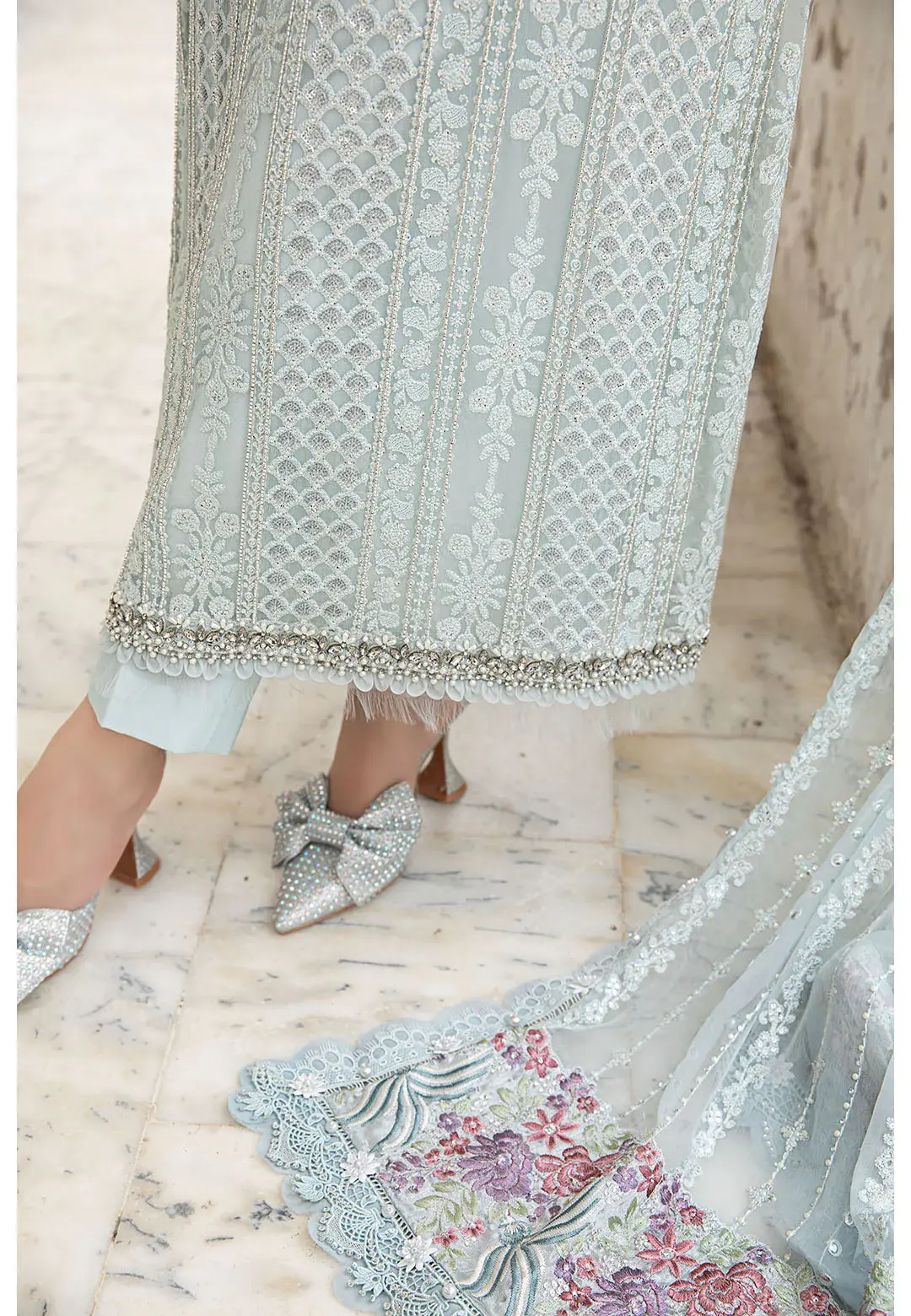 456941546_984541693713095_1039954380302204665_n_1800x1800-1.webp A sophisticated Pakistani formal dress in icy blue, featuring delicate hand embroidery, beadwork, and matching accessories.