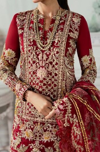 34 Traditional South Asian festive wear—heavily embroidered kameez with a flared sharara and matching dupatta in deep red.