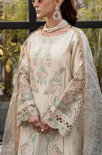 e5 Luxury Pakistani lawn outfit featuring intricate embroidery, pastel floral details, and a lightweight chiffon dupatta, perfect for festive wear.