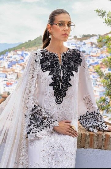 wb4 Stylish white summer outfit with delicate embroidery and a classic black neckline.