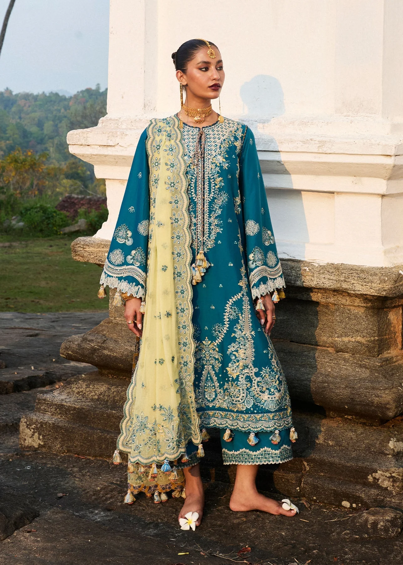 Elegant Teal Blue Outfit with Dupatta and Embellishments Luxury festive wear in teal blue with hand embroidery details.