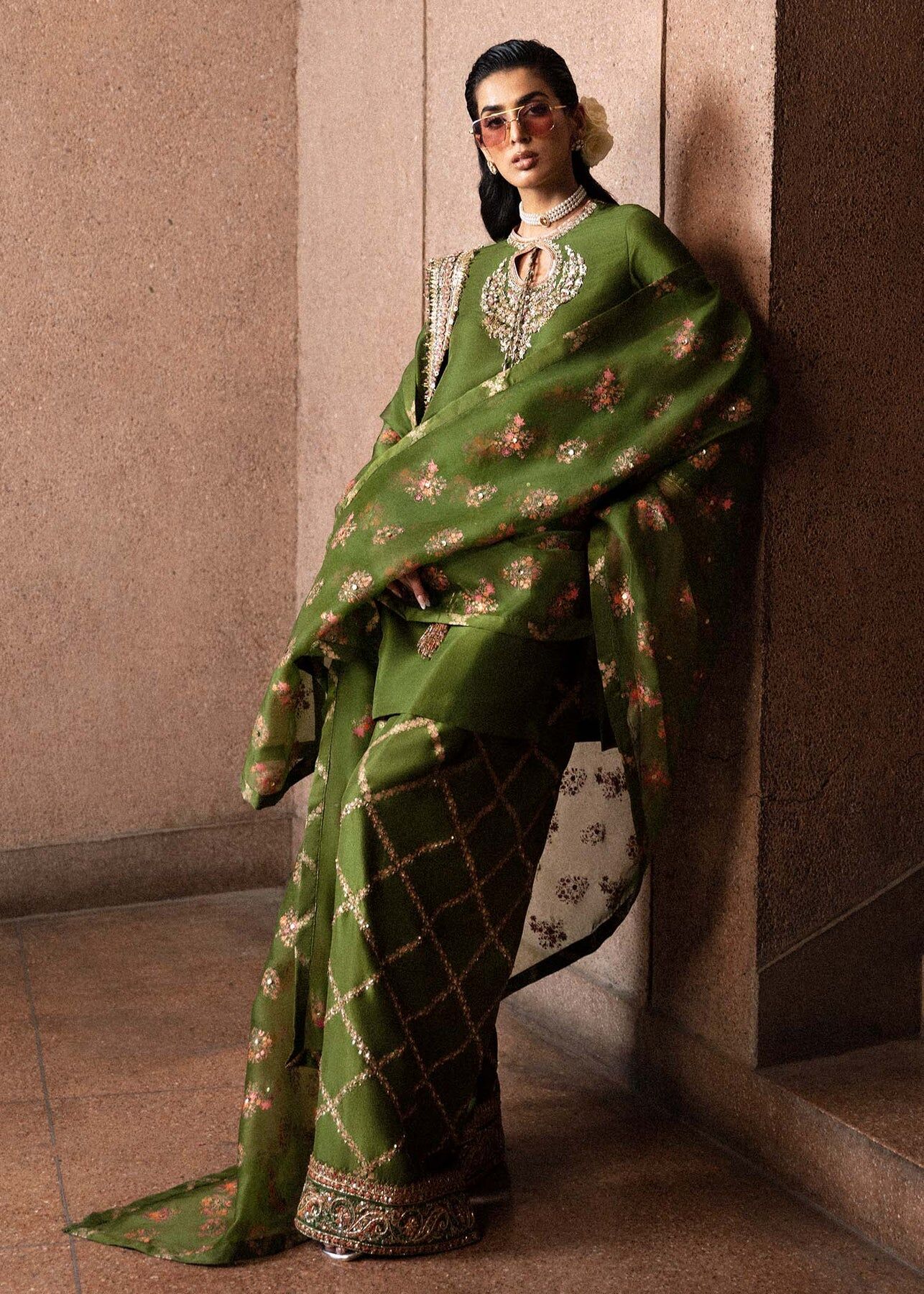 : Luxury Olive Green Designer Saree Style Ensemble Woman wearing olive green saree style designer outfit with embroidery.