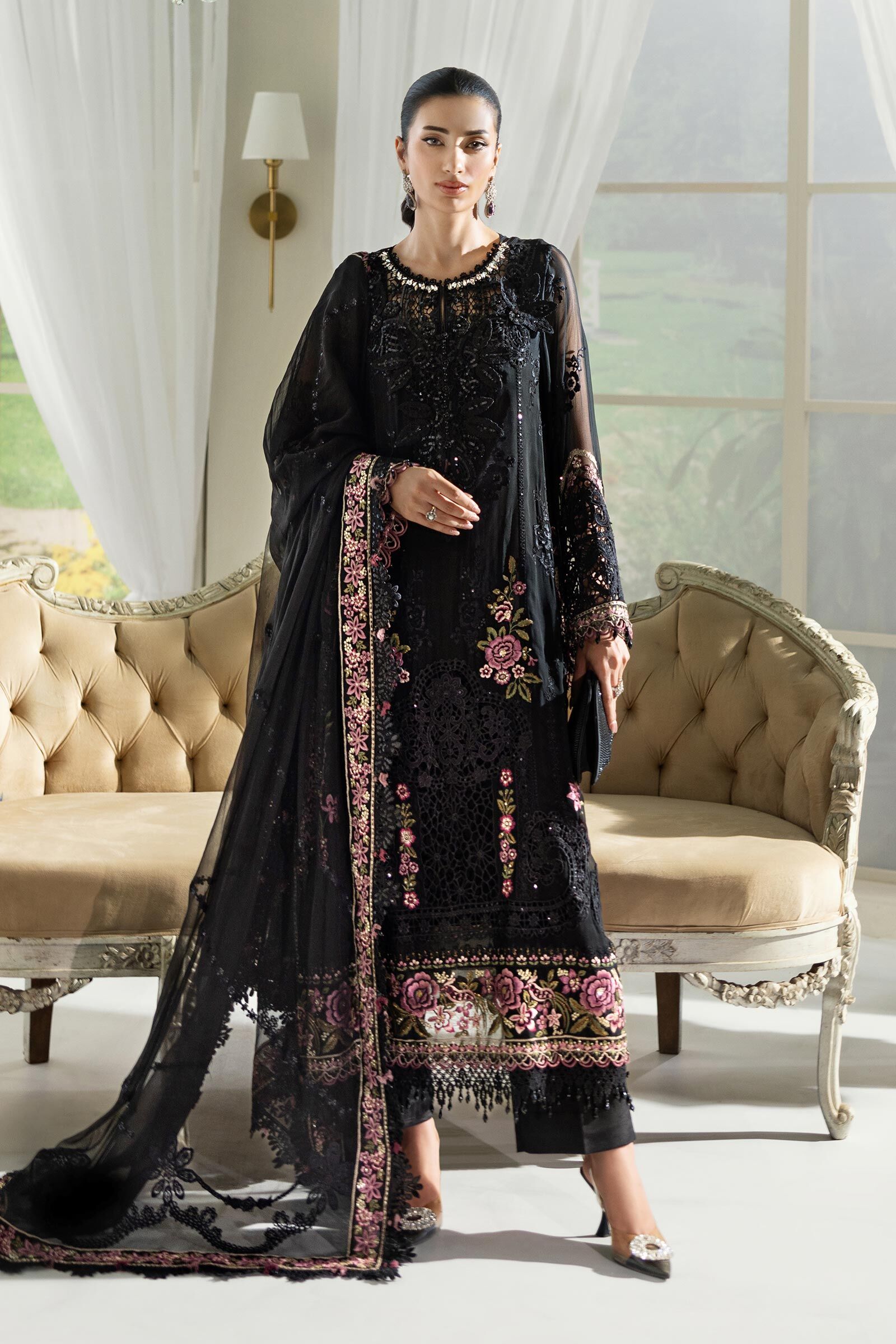 Elegant Embroidered Black Chiffon Suit A full-length photo of a beautiful black Pakistani dress with intricate embroidery and a chiffon dupatta.