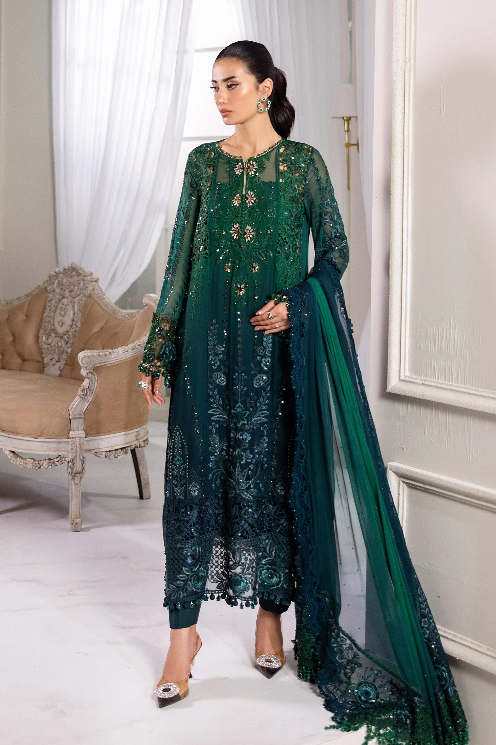 Lovely Green Embroidered Formal Dress A model is wearing a beautiful green embroidered dress** with detailed embroidery and a matching dupatta.