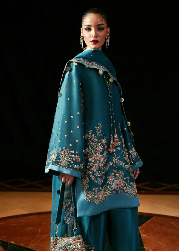 The 'Aab-e-Rawaan' Teal Embroidered Kurta Set An elegant model showcasing a new collection dress for girls, a silk kurta and pants set with detailed floral embroidery