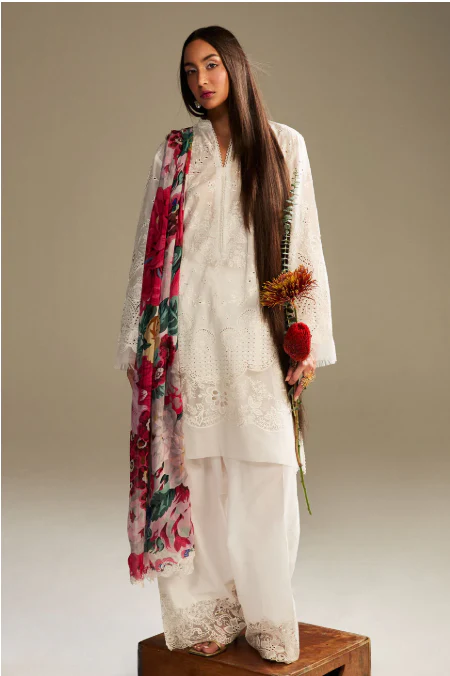 Elegant white embroidered lawn dress with floral dupatta for festive Eid celebrations.